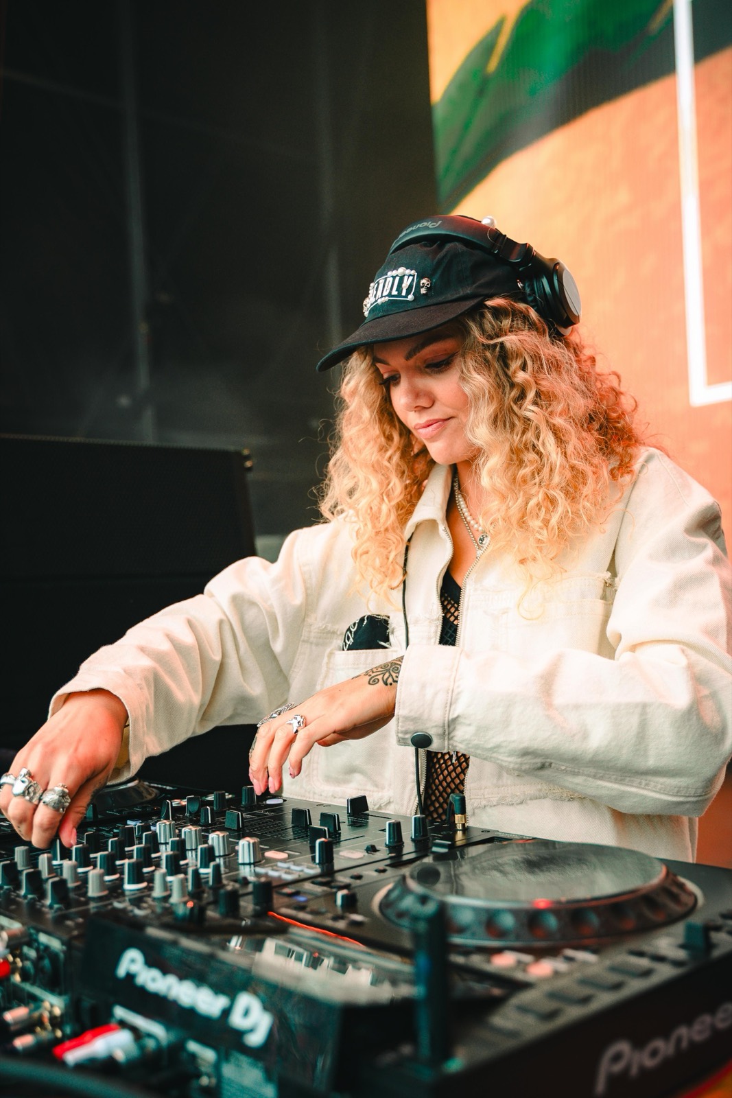 Becca D mixing on Pioneer DJ decks at a festival